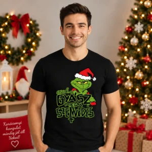 Fiatal férfi fekete Csak a gyászmeg a szenvedés Grinch Pólóban, zöld karácsonyi karakterrel és humoros felirattal.